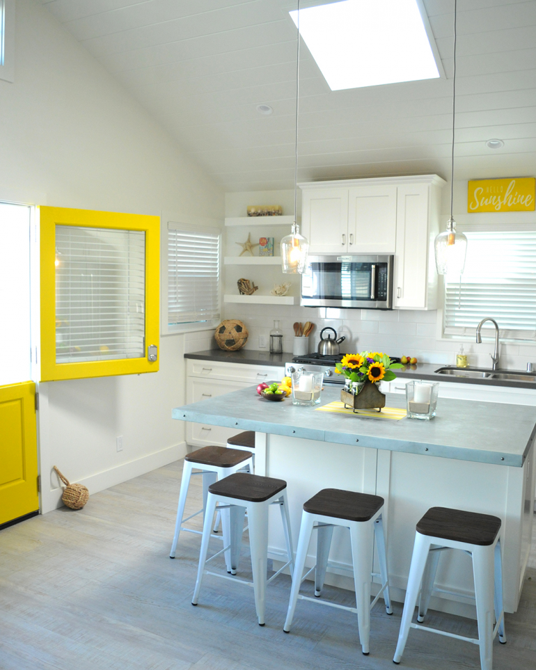 cute bright white kitchen with yellow accents