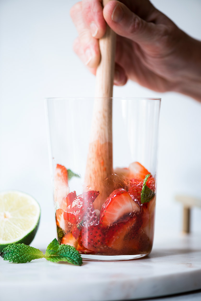 muddling mint and strawberries for mojitos