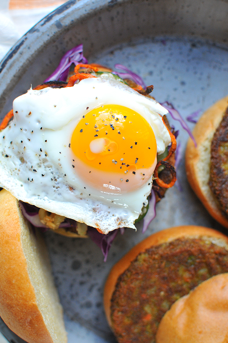 korean bbq bibimbap burgers with fried eggs on top