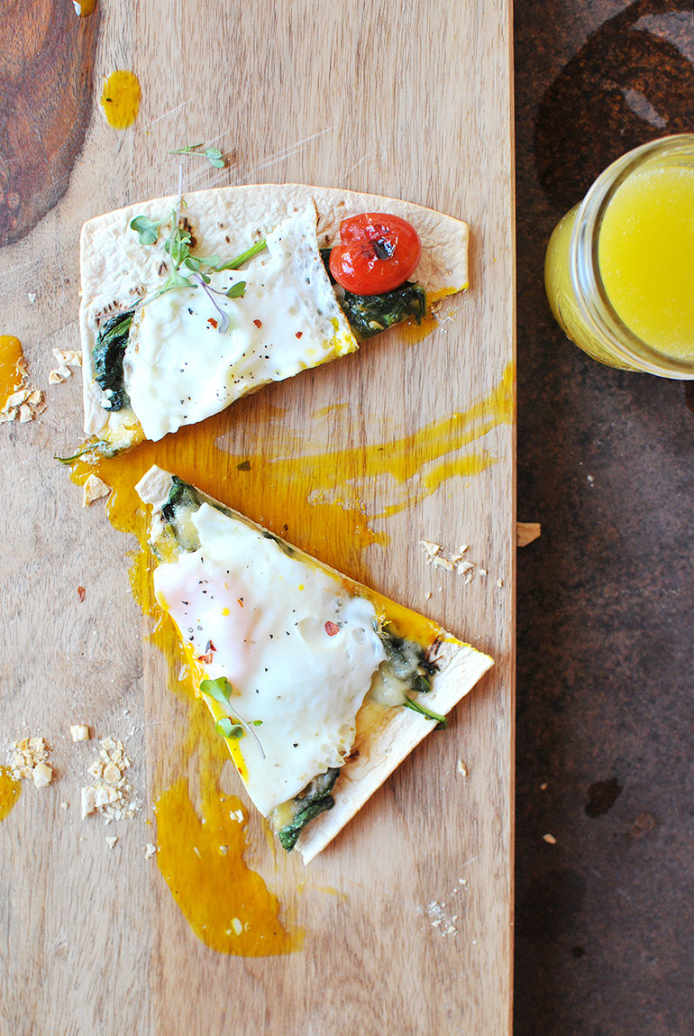 breakfast pizza on cutting board