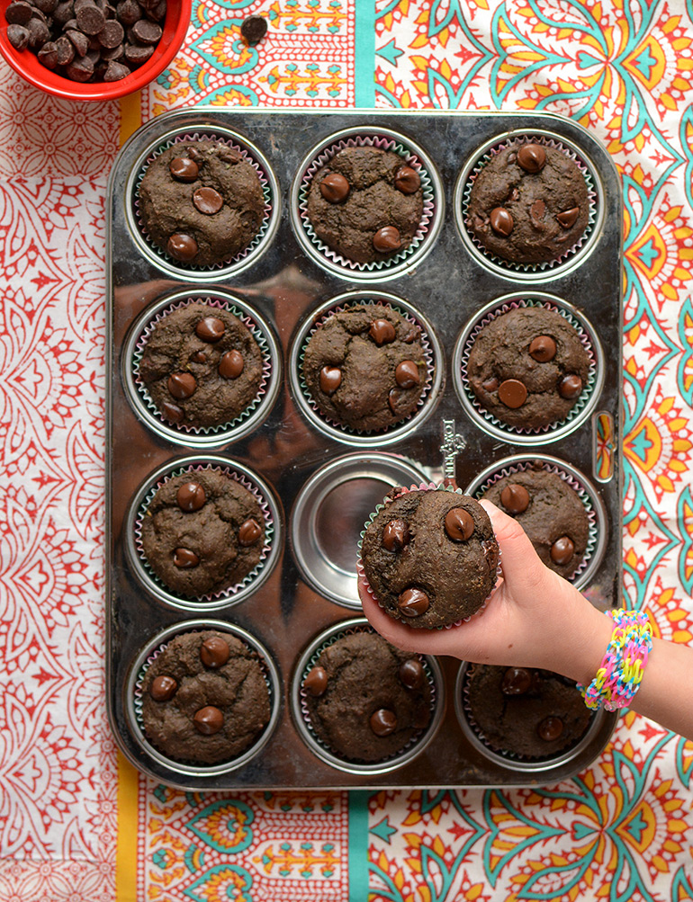 grabbing chocolate avocado muffin