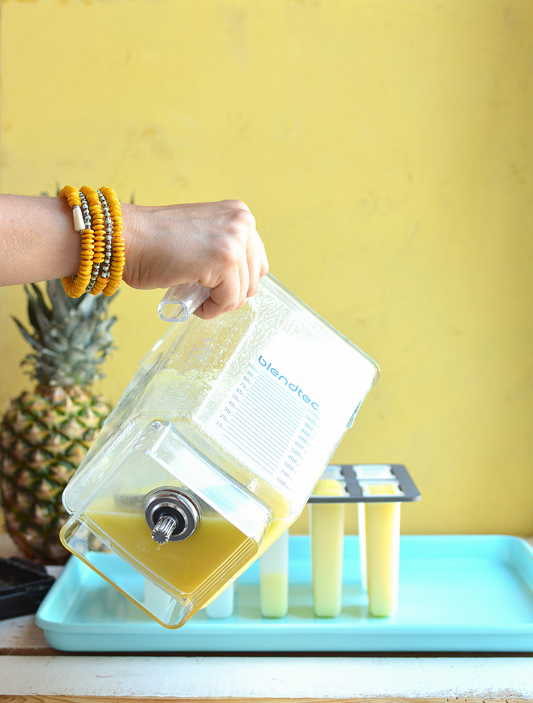 pouring pina colada popsicles into mold