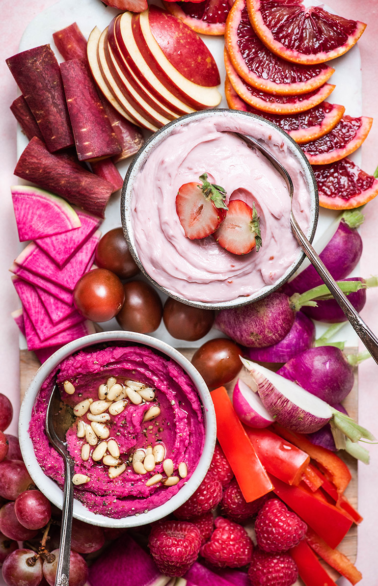 pink vegan snack board with beet hummus