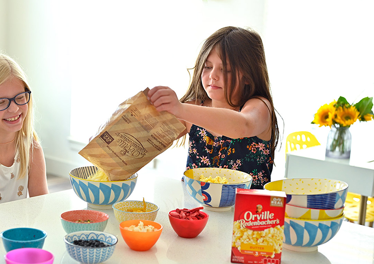 pouring Orville popcorn out of the bag